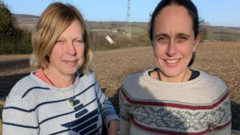 Crops not Concrete Two women standing on a field.