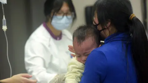 A baby receives care at the pediatric department of a hospital in Hangzhou, eastern China's Zhejiang province, on 6 January 2025