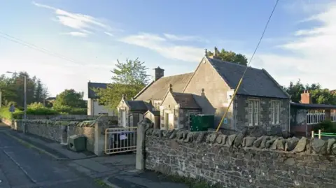 A small school building in the Borders, it is brick built but with a wooden windowed extension