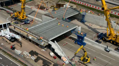 Jordan Pettitt/PA Wire Engineering works taking place at the A3 Wisley interchange at Junction 10 of the M25 as concrete beams for a new bridge are installed