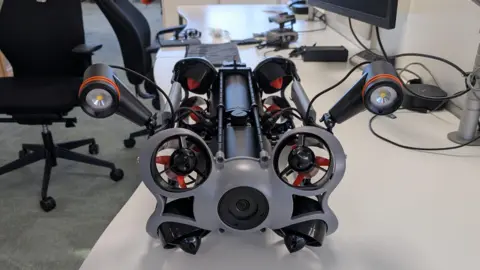 Broads Authority A drone sitting on a desk. There are office chairs in the background.