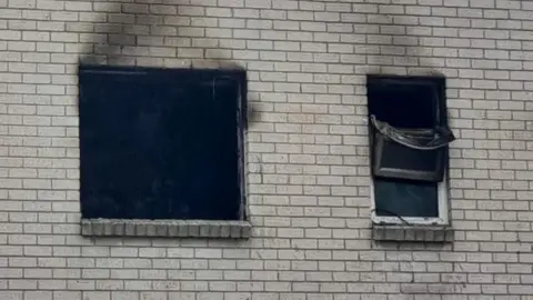 Dorset and Wiltshire Fire and Rescue Service The burnt out windows of the first floor flat