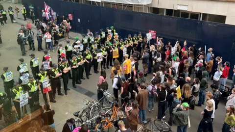 Protesters separated by police.