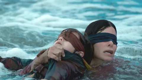 Saeed Adyani/Netflix Sandra Bullock in a still from Bird Box