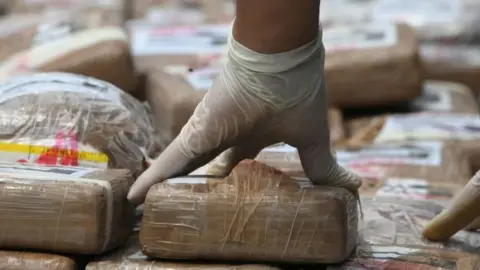 AFP Authorities incinerate a load of cocaine seized to two Colombian nationals navigating along the Caribbean, in Tegucigalpa, on July 11, 2017.