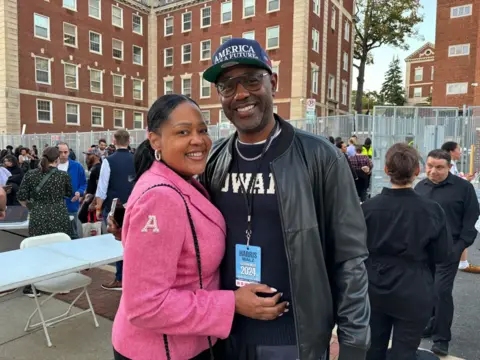 Cheryl Taylor in a pink AKA student jacket, seen with her former colleague Lewis Long. 