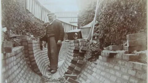 Southern Water A black and white image showing two men laying bricks for Brighton's Victorian sewers