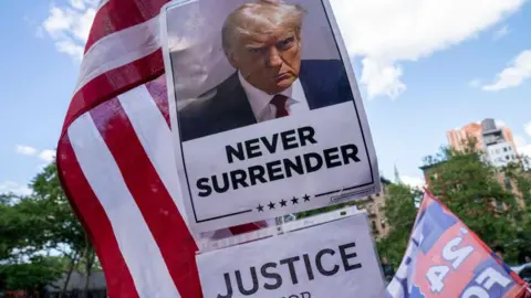 Getty Images A poster of Donald Trump features the words 'Never Surrender' and 'Justice for Trump'