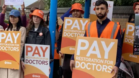BBC, Dr. Chevam Sharma, to the right, in the sit -in line