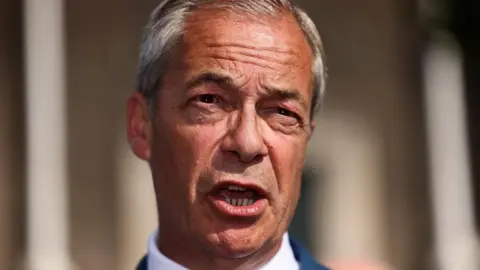 This photo has a close-up of Nigel Farage's face as he is talking to an audience 