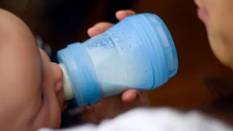 Getty Images A French baby drinks milk from a bottle