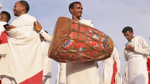 Tiksa Negeri/Reuters Members of the Ethiopian Orthodox choir - one with a drum - perform during the Meskel festival celebration in Addis Ababa, Ethiopia - Wednesday 28 September 2023