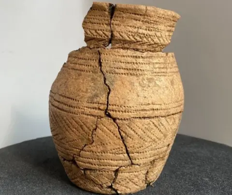 EXPLORE THE PAST A cracked beaker vessel that was uncovered at the Milestone Ground