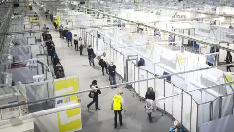 PA Media Health and social care staff queue for a coronavirus vaccine at the NHS Louisa Jordan Hospital in Glasgow, as part of a mass vaccination drive by NHS Greater Glasgow and Clyde. Picture date: Saturday January 23, 2021.