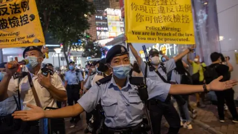 EPA Police officers move on people marking the anniversary of the Tiananmen Square massacre in Hong Kong