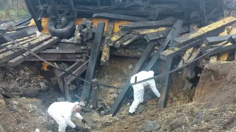 Polish police Polish forensic experts investigate a crater made by falling missile debris in eastern Poland. Photo: November 2022