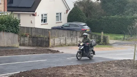 Dean Piacentini A motorcyclist rides on a newly resurfaced road 