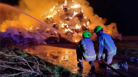 Essex Fire and Rescue Service Firefighters tackle straw bale fire