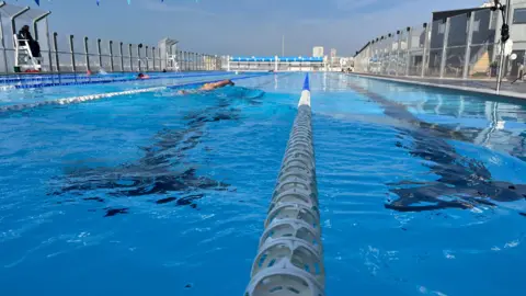 BBC / George Carden Sea Lanes pool with dividing white plastic floats between lanes separating crystal blue water