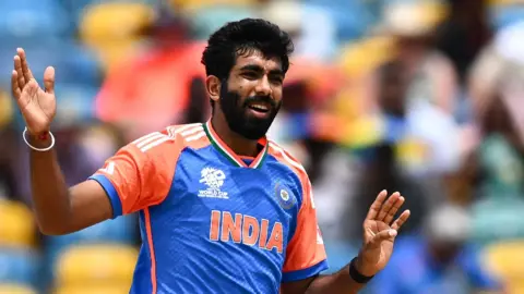 India fast bowler Jasprit Bumrah with his arms raised