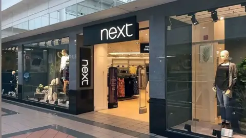 A Next retail outlet in Dumfries with clothing in the window