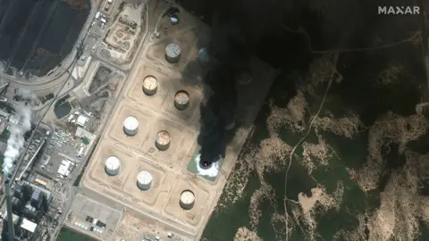 MAXAR TECHNOLOGIES An oil storage facility in southern Israel burns after it was hit by rocket fire from Gaza