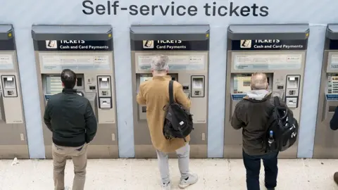 People using ticket machines