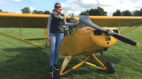 Bristol Groundschool Hannah Kerr from Bristol Groundschool smiling at the camera standing by a small propellor plan