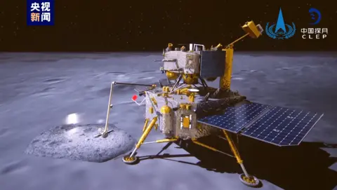 CNSA Screengrab of video published by China's space agency depicting the robot craft pulling out a Chinese flag and waving it up and down on the moon surface