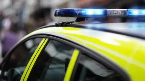 Top of police car with blue light on.