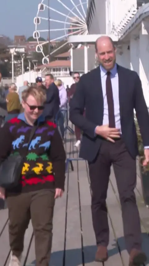 Prince William walks down Bournemouth Pier. 