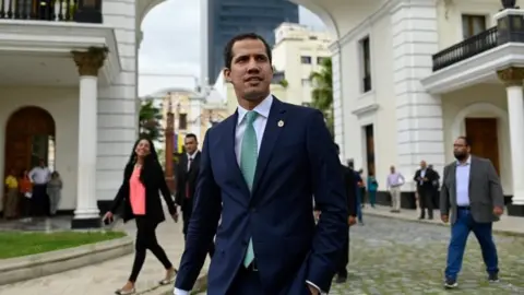 AFP Venezuelan opposition leader and self-proclaimed interim president Juan Guaido arrives for a session of the Venezuelan National Assembly in Caracas on July 30, 2019.