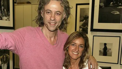 Bob Geldof and Dame Claire attend the Live Aid  private view at the Getty Images Gallery in 2005. Geldof has his arm around Ms Bertschinger.