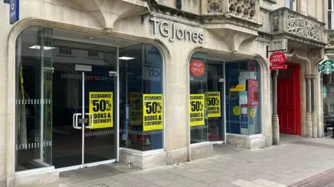 A general view of the outside of the TGJones store in Ipswich. Large yellow sale signs can be seen in the front windows.