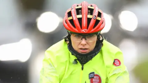 Comic Relief Mollie King cycling for Red Nose Day in wet conditions