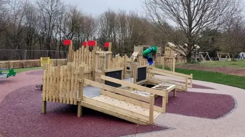 The Coates Park Country Park's fully accessible play area with a wooden ram and wheelchair accessible play 