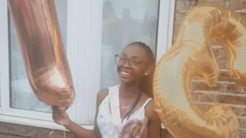 LEIGH DAY A smiling Hannah Jacobs poses with birthday balloons 