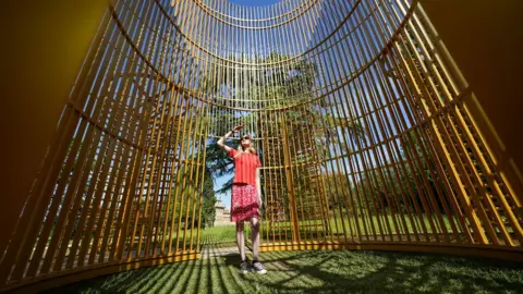 PA Media Hannah Vitos observes The Blenheim Art Foundation interactive sculpture by Chinese artist Ai Weiwei which will go on long-term view in the grounds of Blenheim Palace in Woodstock, Oxfordshire