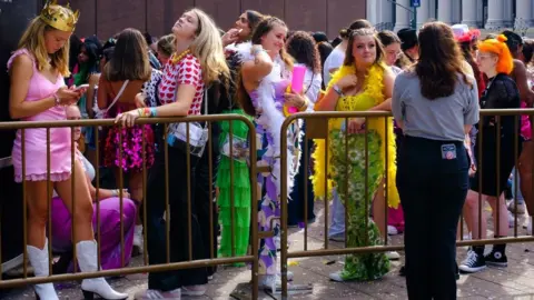 Getty Images Fans wearing feather boas and 70s clothes