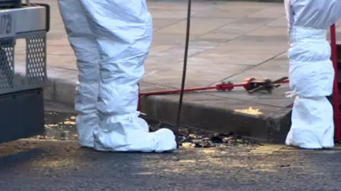 BBC PSNI forensic officers examining the murder scene