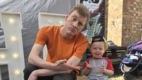 James Acaster poses with a boy at Sunday's event