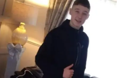 Family handout A young man gives a thumbs up to the camera