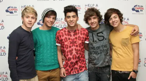 PA Media Niall Horan, Louis Tomlinson, Zayn Malik, Liam Payne and Harry Styles pose for photos in London 