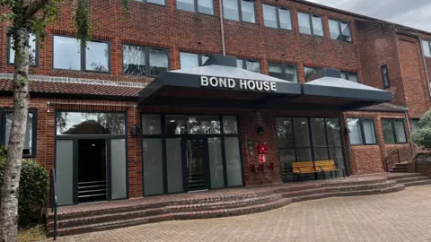 A three-storey building which says "Bond House" on the front of it.