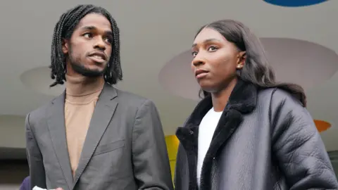 PA Media Athletes Bianca Williams and Ricardo Dos Santos speak to the media in October 2023 outside Palestra House, central London, after the judgement was given for the gross misconduct hearing of five Metropolitan Police officers over their stop and search.