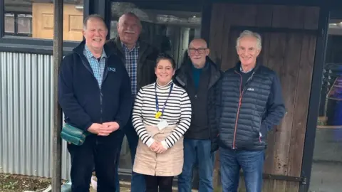 SaTH NHS Trust Four men and a woman stand smiling at the camera outside a building