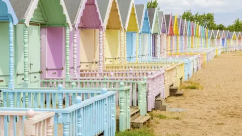 Getty Images Soft pastel colored beach huts in West Mersea, Mersea Island, Essex