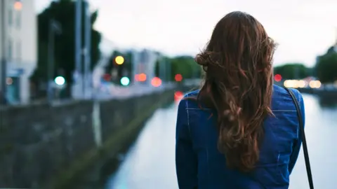 Getty Images Woman walks with back to camera (stock image)