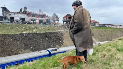 Jewan Abdi A man looks at the site of a Russian attack in Lviv