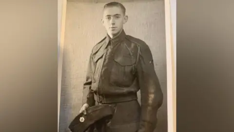 Ken Hobbs as a young man in uniform, in a black and white image.